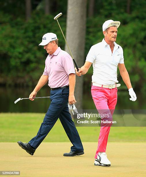 Jesper Parnevik of Sweden waves to the gallery on the 11th green as Jeff Maggert looks on during the final round of the Insperity Invitational at The...