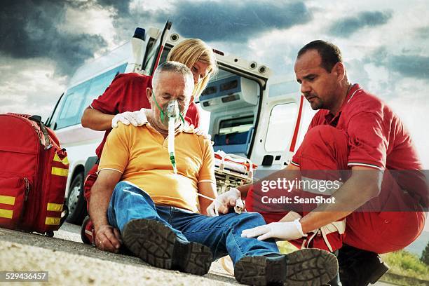 emergency service rescuing an infarcted - victim services stock pictures, royalty-free photos & images