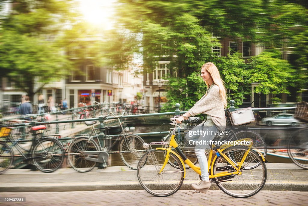 Woman tourist cycling on amsterdam