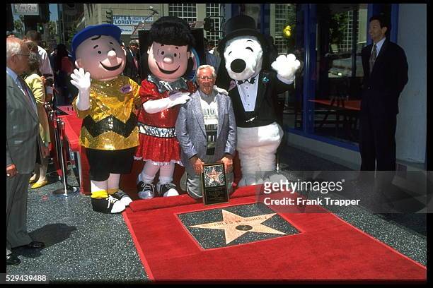 Charles Schulz with the characters of 'Peanuts' : Charlie Brown, Lucy & Snoopy.