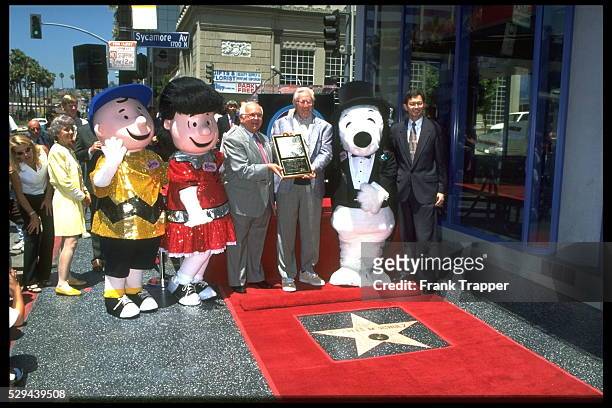 Charles Shulz with the characters from his comic strip 'Peanuts' : Charlie Brown, Lucy & Snoopy.
