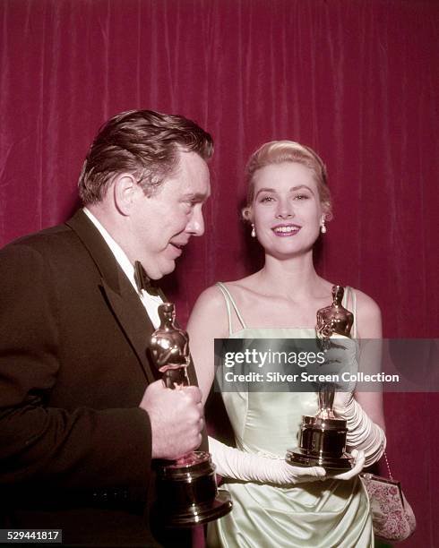 American actors Edmond O'Brien and Grace Kelly with their Oscars at the 27th Academy Awards ceremony, held at the RKO Pantages Theatre in Hollywood,...