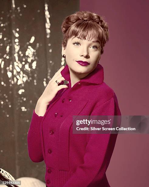 American actress Shirley MacLaine wearing a pink, knitted top, circa 1957.