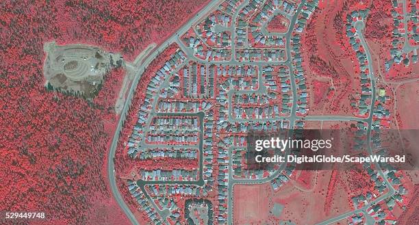 DigitalGlobe via Getty Images BEFORE-4 infrared satellite image of a neighborhood in Fort McMurray, Alberta, Canada before the devastating wildfire...