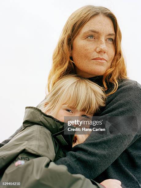 a portrait of a mother hugging her daughter - family looking at camera stock pictures, royalty-free photos & images