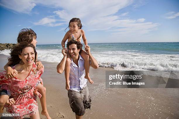 family at the beach - beach family stock-fotos und bilder