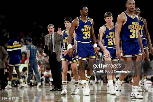 Karl Malone and John Stockton of the Utah Jazz head onto court after meeting with head coach Jerry Sloan against the Atlanta Hawks at the Omni circa...