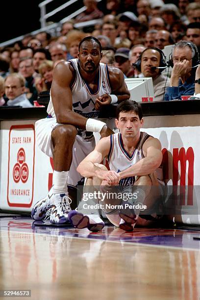 Karl Malone and John Stockton of the Utah Jazz wait to get into the game near the scorer's table during the NBA game at the Delta Center circa 1998...