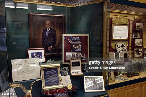 Display shows photographs of Wal-Mart founder Sam Walton's meetings with U.S. Presidents and the Medal of Freedom awarded by Bush Sr. In 1992, March...