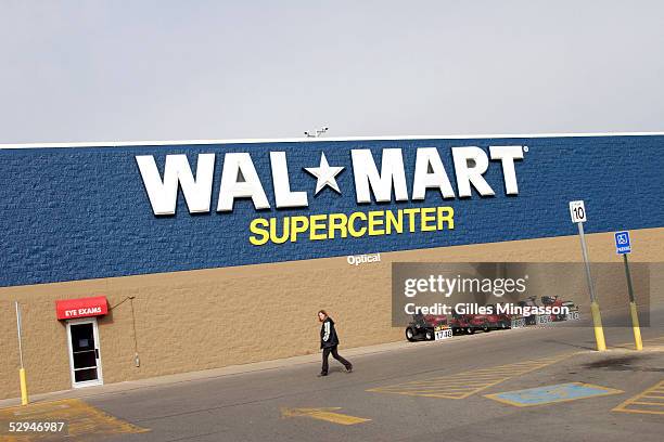 Shopper walks in front a a supercenter Wal-Mart, March 14, 2005 in Bentonville, Arkansas, USA. Based in the small town of Bentonville, Arkansas ,...