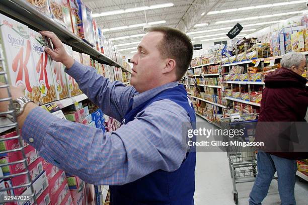 Store manager Matt Lovelace re-stocks cereal at a Bentonville Wal-Mart, March 14, 2005 in Bentonville, Arkansas. Based in the small town of...