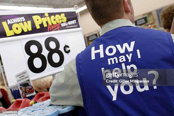 Like all his colleagues in the company's 5,307 stores, a Bentonville Wal-Mart employee wears the company's customer service slogan on his jacket,...