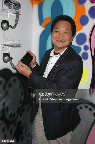 Sony President and Group CEO Ken Kutaragi holds PlayStation controller at Sony Computer Entertainment's PSP Factory Party at Hollywood Center Studios...