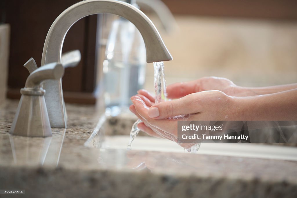 Woman running water on hands