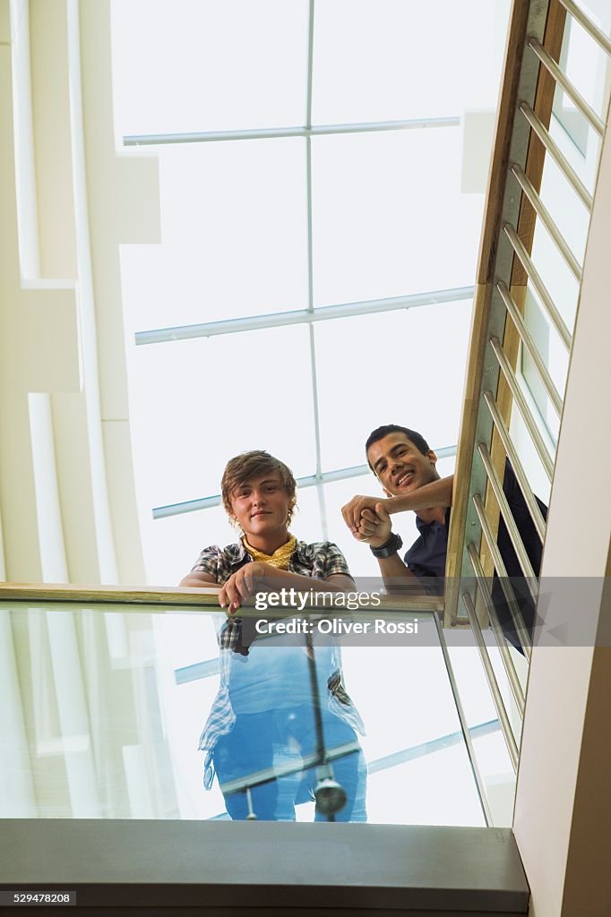 Teen boys leaning on railing