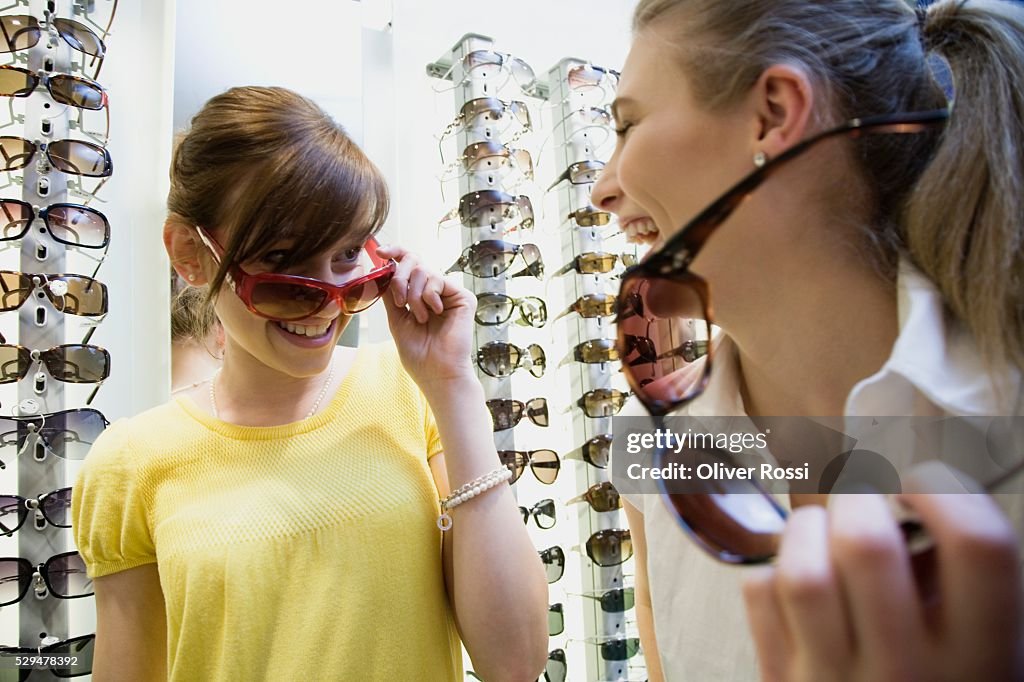 Friends trying on sunglasses