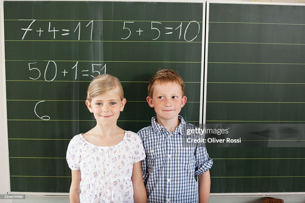 Children in front of blackboard