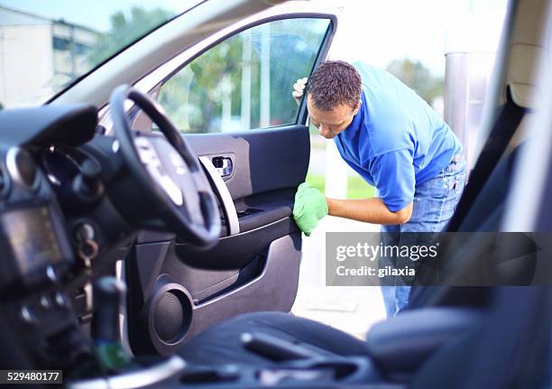 man cleaning interior of his car. - clean car stock pictures, royalty-free photos & images