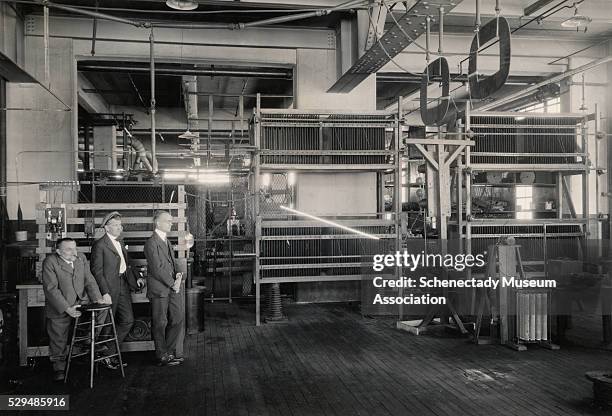 Dr. Charles P. Steinmetz, his son Joseph L. Hayden, and his assistant N.A. Lougee experiment with artificial lightning in Steinmetz' laboratory at...