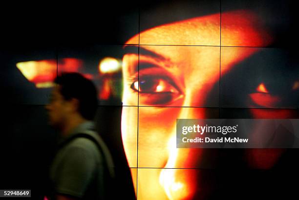 Visitor walks pasts a set of eyes on a video monitor at the 11th annual Electronic Entertainment Expo on May 18, 2005 in Los Angeles, California....