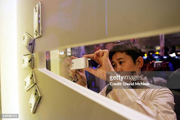 Visitor takes a picture of the new Nintendo Gameboy Micro with a cell phone at the 11th annual Electronic Entertainment Expo on May 18, 2005 in Los...