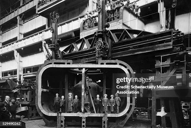 Midgets from the Alice in Toyland Vaudville troupe visit General Electric Building No. 60 and pose inside a 40,000 HP turbine casting.