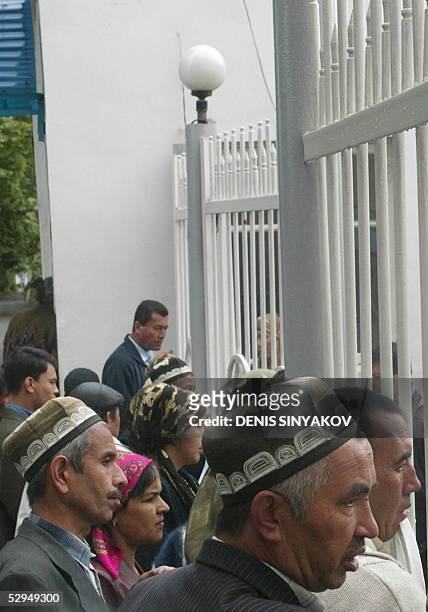 Relatives of people wounded during clashes between government forces and local protesters in the eastern Uzbekistan town of Andijan gather in front...