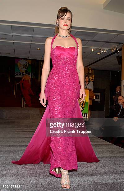 Fashion model Yulia wears Colleen Quen fuschia tulle swirl gown with train and Harry Winston diamond and sapphire necklace, 49 cts., bracelet, 21...