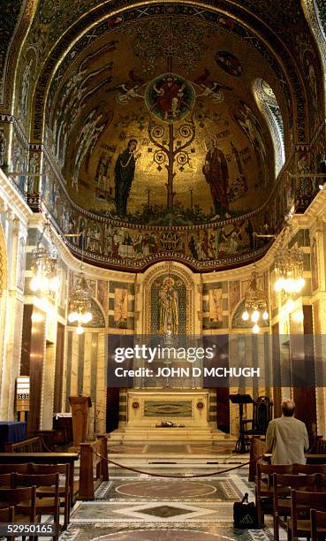 An unidentified man prays in the Chapel of the Blessed Virgin Mary in Westminister Cathedral in London, 19 May, 2005. Roman Catholics and Protestants...