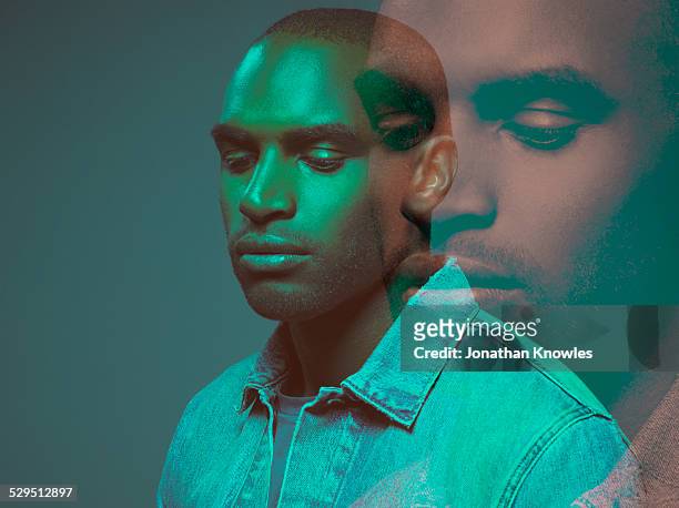 multiple exposure, dark skinned male, looking down - same person different looks - fotografias e filmes do acervo