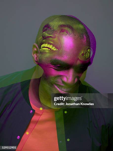 multiple exposure, dark skinned male laughing - mehrfachbelichtung stock-fotos und bilder