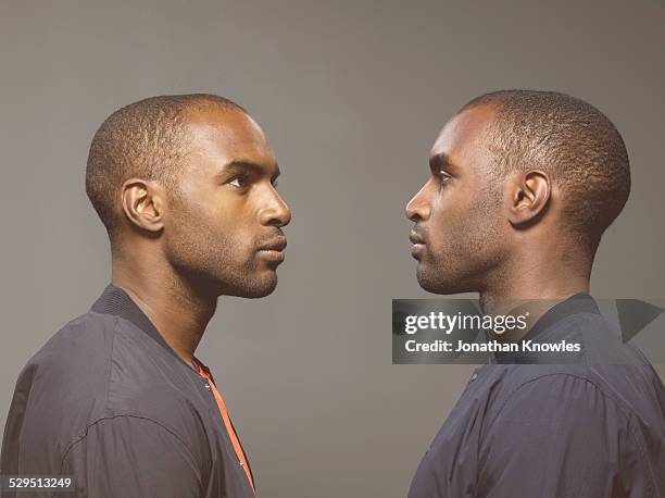 twin image, dark skinned male - same person different outfit foto e immagini stock