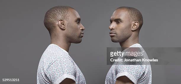 twin image, dark skinned male - multiple images of the same person stock pictures, royalty-free photos & images