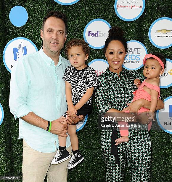 Adam Housley, Aden John Tanner Housley, Tamera Mowry and Ariah Talea Housley attend Safe Kids Day at Smashbox Studios on April 24, 2016 in Culver...
