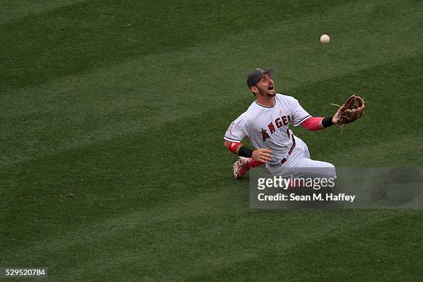 Johnny Giavotella of the Los Angeles Angels of Anaheim slides to catch a fly ball hit by Tampa Bay Rays Steve Pearce during the sixth inning of a...