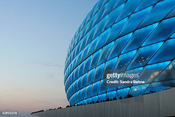 The new Allianz Arena football stadium is illuminated during an exhibition match between the traditional teams of 1860 Munich and Bayern Munich on...