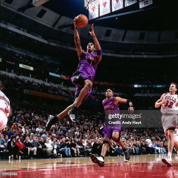 Tracy McGrady of the Toronto Raptors goes for a layup against the Chicago Bulls during an NBA game at the United Center circa 2000 in Chicago,...