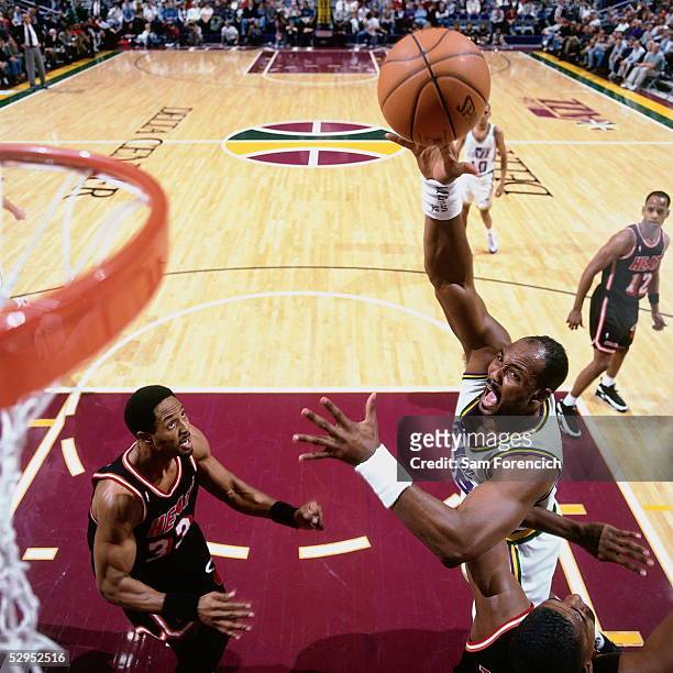 Karl Malone of the Utah Jazz shoots a baby hookshot in the lane against the Miami Heat at the Delta Center circa 1996 in Salt Lake City, Utah. NOTE...