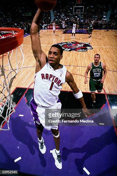 Tracy McGrady of the Toronto Raptors goes for a dunk against the Boston celtics during an NBA game at the Air Canada Center in Toronto, Ontario,...