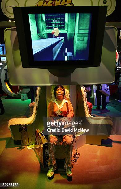 Woman plays Pac Man World 3 powered by an XBox 360 game console in the Microsoft Corp. Exhibit area at the 11th annual Electronic Entertainment Expo...