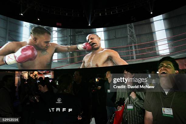 Visitors watch a demonstration of the EA Sports game, Fight Night Round 3, on a 360 degree screen at the 11th annual Electronic Entertainment Expo on...