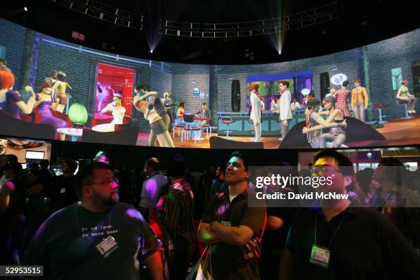 Visitors watch a demonstration of the EA game, The Sims 2, on a 360 degree screen at the 11th annual Electronic Entertainment Expo on May 19, 2005 in...