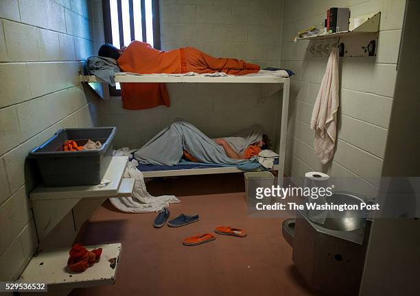 Two inmates, likely ill from opiate detox, are monitored in the medical care portion of the Cumberland County jail in Portland, ME on July 2, 2015....