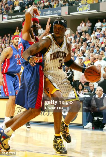 Jermaine O'Neal of the Indiana Pacers heads for the basket as Richard Hamilton of the Detroit Pistons defends in Game six of the Eastern Conference...