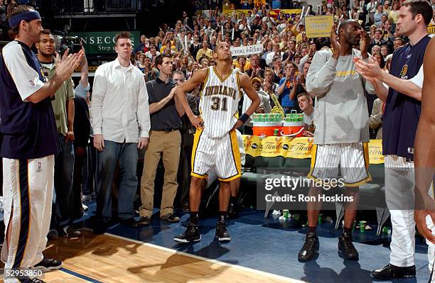 Reggie Miller of the Indiana Pacers takes in a standing ovation after coming out of his last career NBA game, in the final seconds against the...