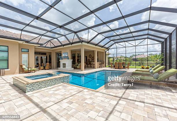 outdoor dining and swimming pool - luxury mansion interior stock pictures, royalty-free photos & images