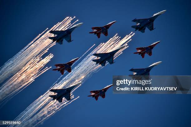 Russian Su-27 jet fighters and MIG 29 jet fighters fly over Red Square during the Victory Day military parade in Moscow on May 9, 2016. - Russia...