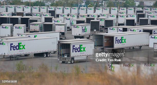 Fed-Ex Ground trailors sit idle at a distribution center in Rialto, CA. The trade slump has brought job layoffs and steep declines in shipped goods.