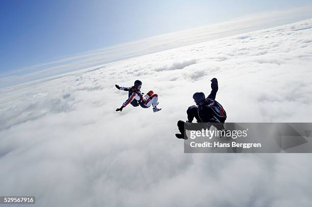 two people flying above clouds - 重力場 ストックフォトと画像