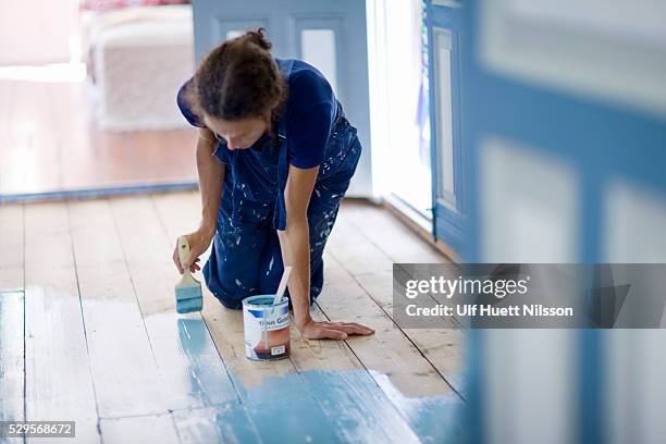 woman painting wooden floor - diy painting stock pictures, royalty-free photos & images